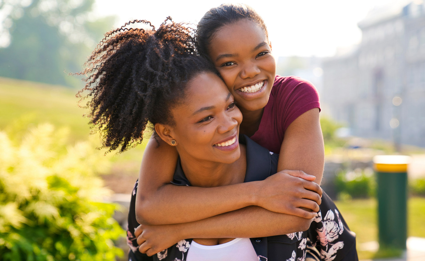 black mother and daughter hugging