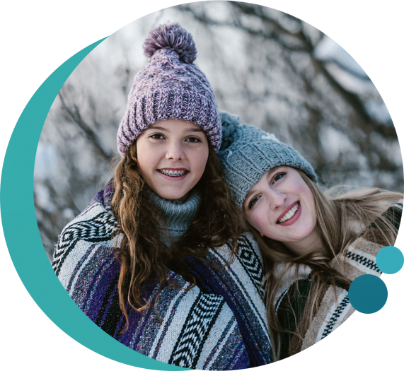 caucasian mother and young daughter outside in winter clothes