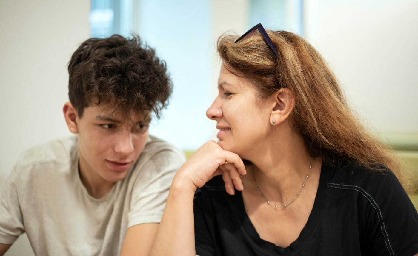 a caucasian youth with his mother